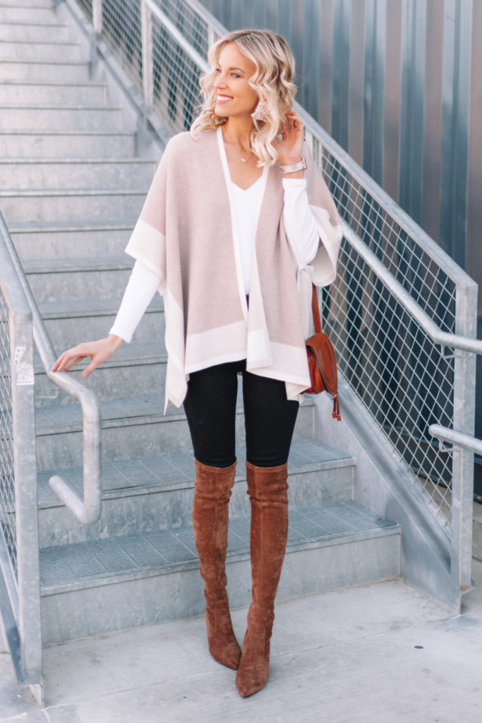 Neutral Poncho Wrap 4 Ways, black jeans with white t-shirt, over the knee boots, and poncho wrap sweater
