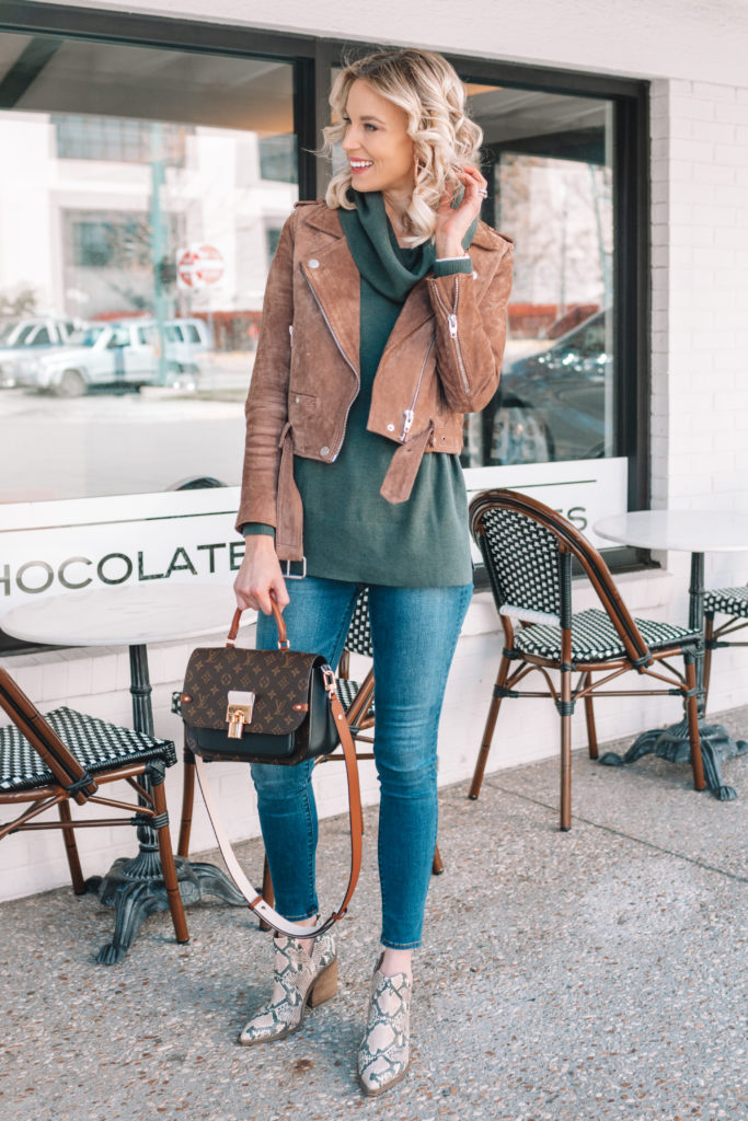 turtleneck tunic sweater with a suede moto jacket and snakeskin boots