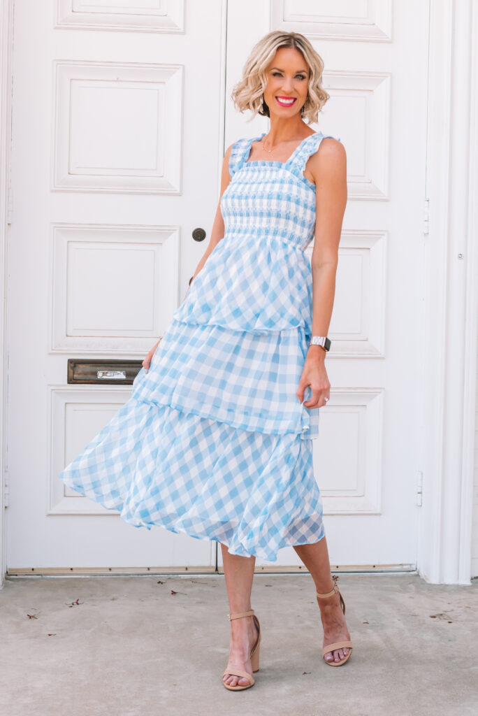 This is the most gorgeous blue gingham midi dress! It is true to size, has the most gorgeous smocking, tiers, and ruffle straps. I highly recommend it!! It would be the perfect wedding guest dress this summer. 