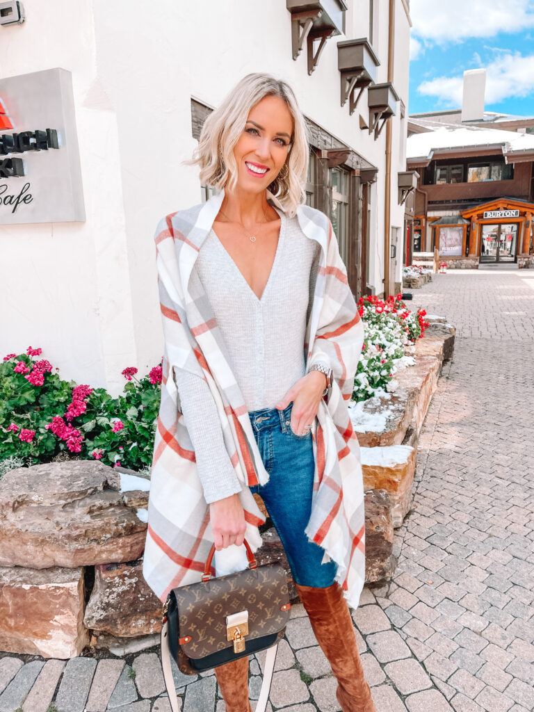 This plaid wrap is such a fun piece for fall and can be worn so many ways! Today I styled it with regular skinny jeans and my over the knee boots.