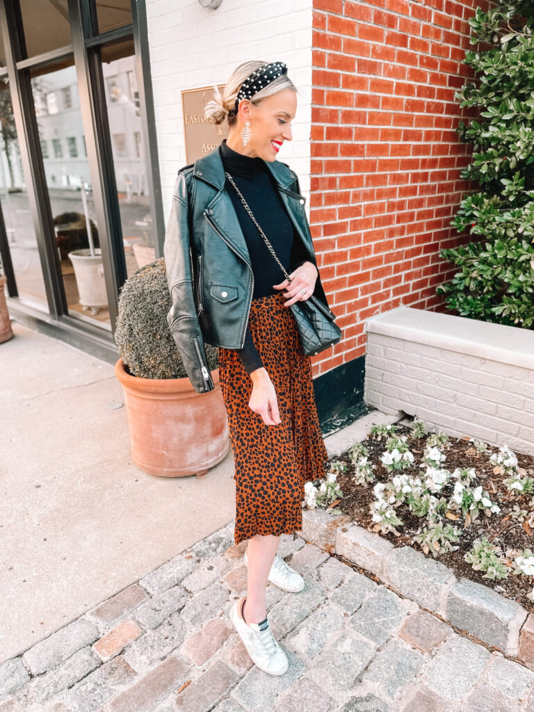 I love this cool girl take on a midi skirt! Add a black turtleneck and a leather jacket with sneakers to a leopard skirt and you're good to go!