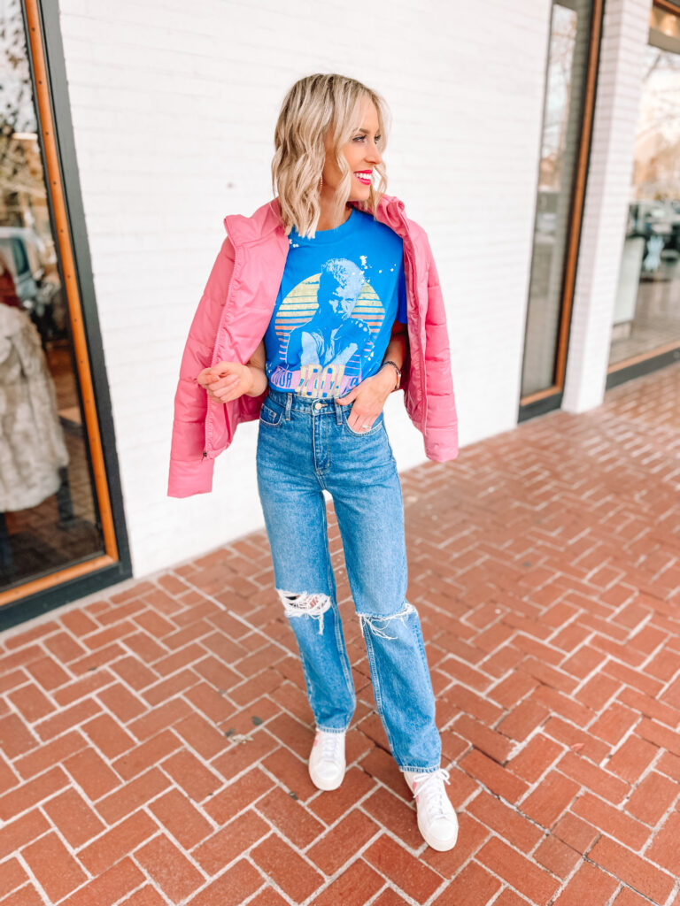 Curious what jeans are in style for 2022? Wide leg jeans are in style for 2022 plus other fun styles! I'm sharing how to wear them plus more! I love this pair with a tucked in band tee and pink puffer coat.