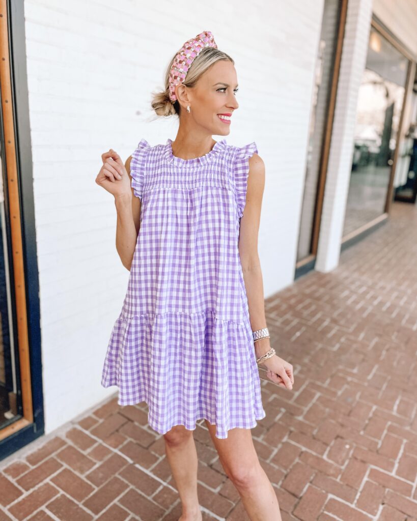 This short purple gingham dress with the ruffle shoulder is seriously adorable! Use code AMYANN15 for a discount too making it under $50. Click to shop. 