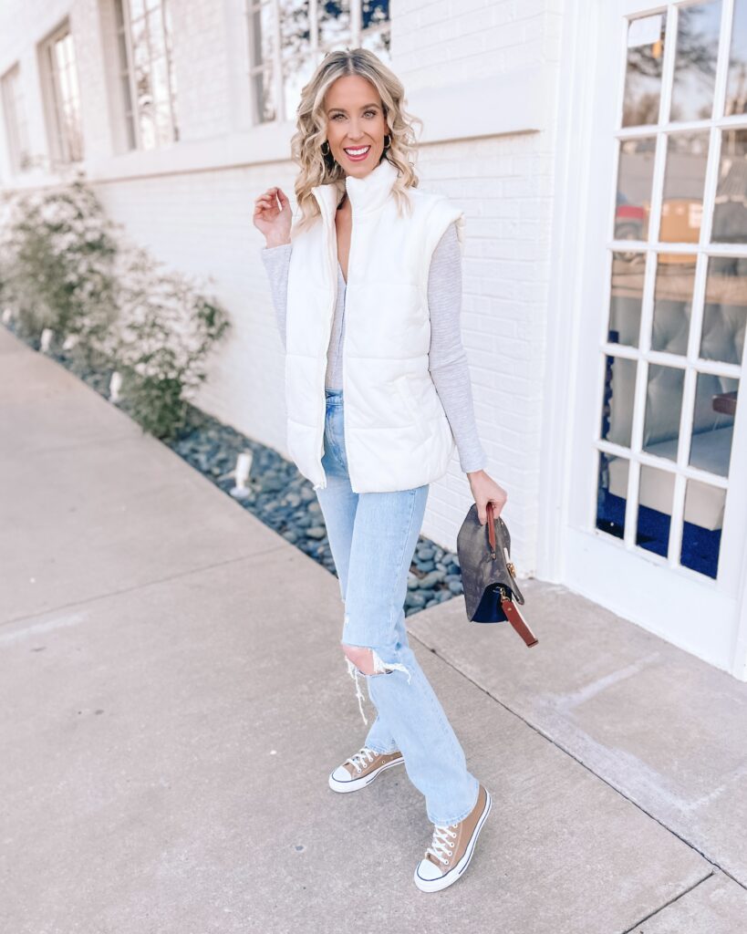 You'll love this long puffer vest outfit! I paired it with a henley bodysuit, straight leg jeans, and converse for a street style cool look.