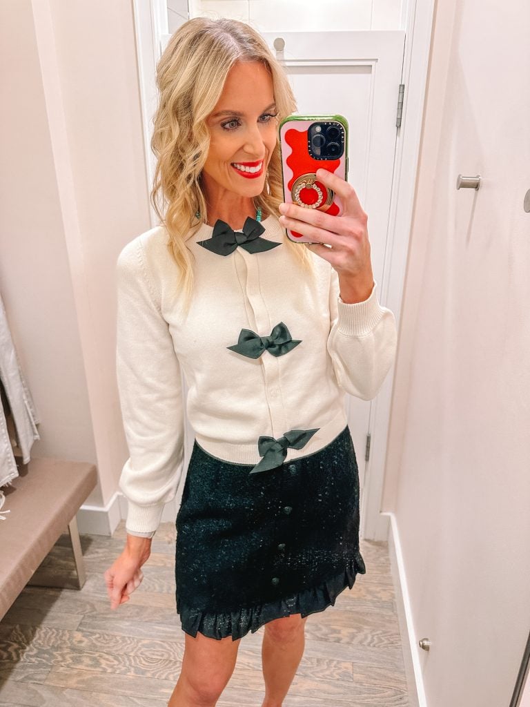 I have a HUGE LOFT try on haul for you with ELEVEN outfit ideas complete with holiday outfit ideas and winter outfits. From dressy to casual, festive and fun, I have it all! Starting with this bow sweater and tweed skirt!